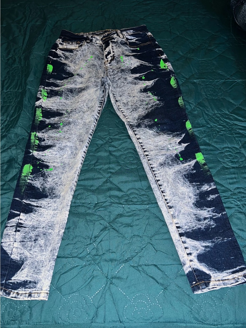 Woman Acid-Wash Blue Jeans with Neon Green Paint Splatter